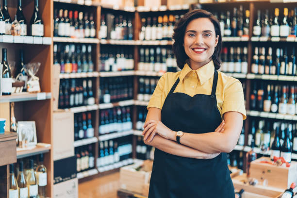 Smiling young female wine shop owner