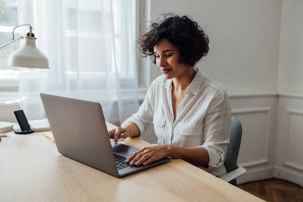 A mixed-race businesswoman being busy typing on her computer. Agence web Paris 11