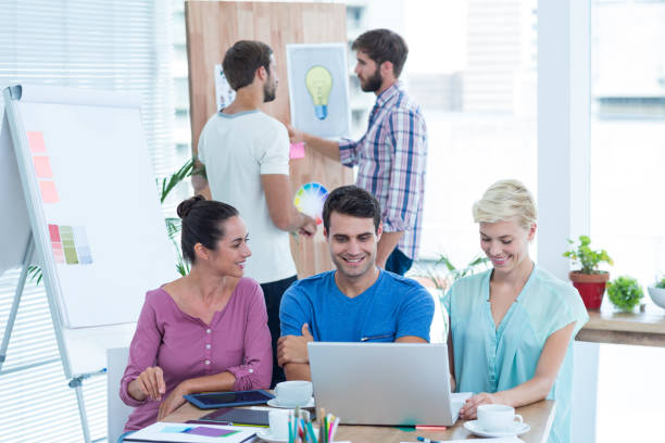 Creative business people using laptop in meeting at office agence gentleview. communication digitale lyon