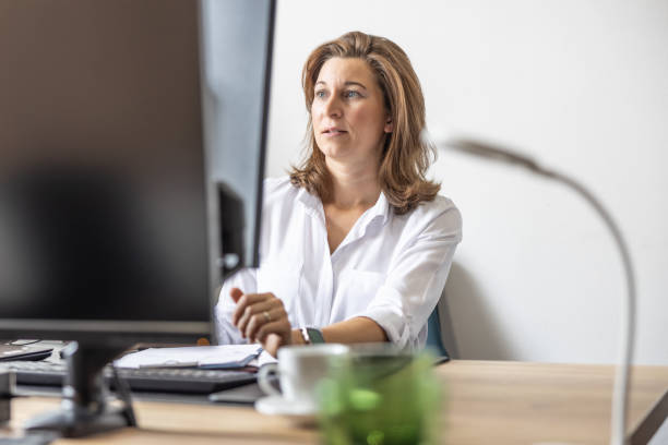 An accountant or businesswoman works in her office at a computer.