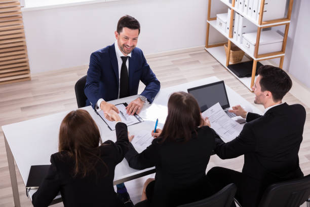 High Angle View Of Young Businesspeople Having Conversation In Office agence web Sentier