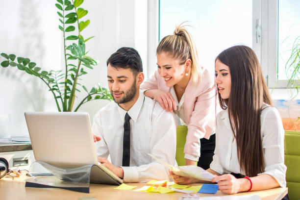 Young business people working together in bright office. agence web Arts-et-Métiers