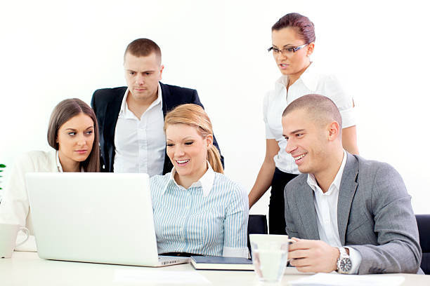 Young business team in office. Business woman shows something on laptop. agence web Place Vendôme