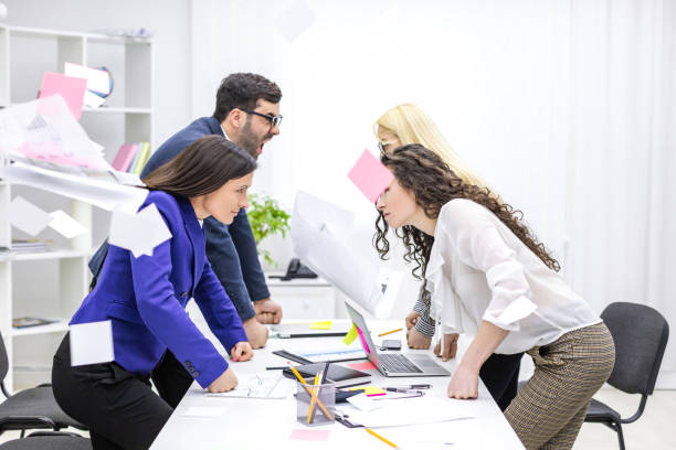 Photo of four businesspeople having lively discussion. Office interior. agence gentleview. communication digitale lyon