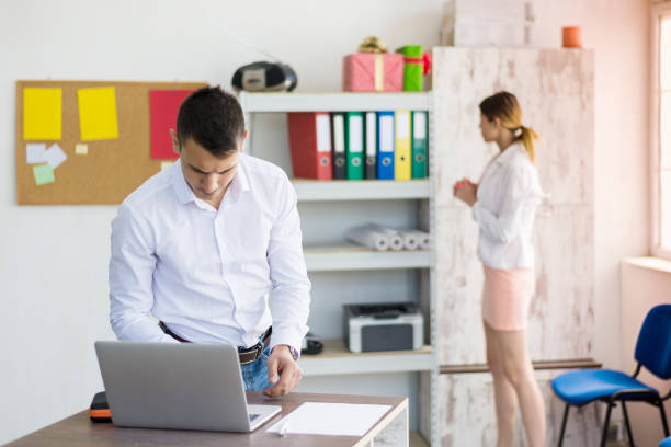 Two business colleagues work at the firm's office