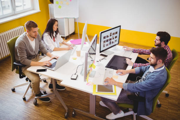 High angle view of young editors working at creative office